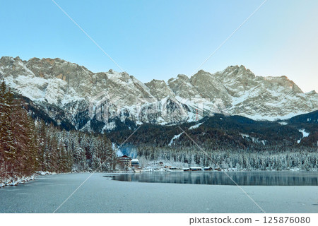 Majestic Frozen Eibsee Lake Reflects Icy Mountain Peaks Under Early Morning Light Pristine Winter Wonderland Captures Nature's Serenity with Snow-Covered Zugspitze in the Background Majestic Frozen Eibsee Lake Reflects Icy Mountain Peaks Under Early Morning Light Pristine Winter Wonderland Captures Nature's Serenity with Snow-Covered Zugspitze in the Background 125876080