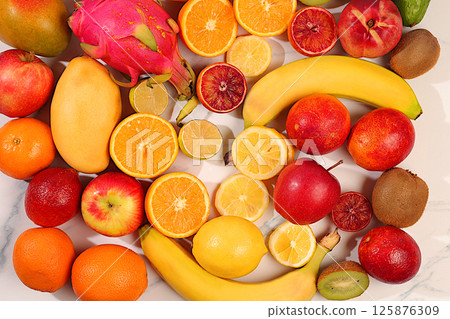 Banner with tropical exotic fruits on concrete background, summer vacation and healthy lifestyle concept. Advertising card for market or store. Healthy vegan food for weight loss. Banner with tropical exotic fruits on concrete background, summer vacation and healthy lifestyle concept. Advertising card for market or store. Healthy vegan food for weight loss. 125876309