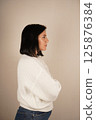 Businesswoman isolated, businesswoman standing with arms crossed and smiling, front view. Half-side view. 125876384