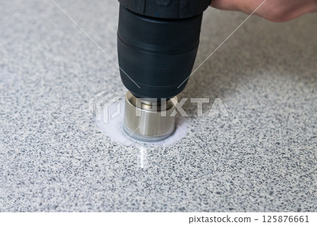 rotating diamond core hole cutter in hand power drill drills stone slab rotating diamond core hole cutter in hand power drill drills stone slab 125876661
