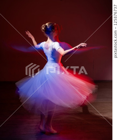 Caucasian woman dancing classical dance in tutu . Long exposure photo.  125876737