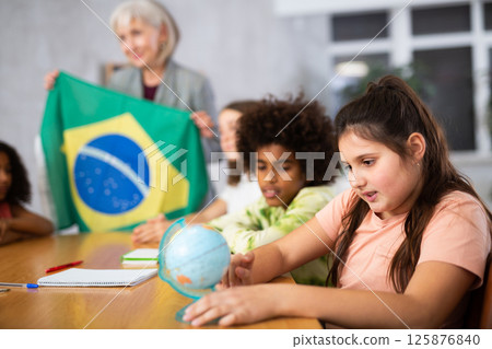 students listen to woman teacher who talks about Brazil 125876840