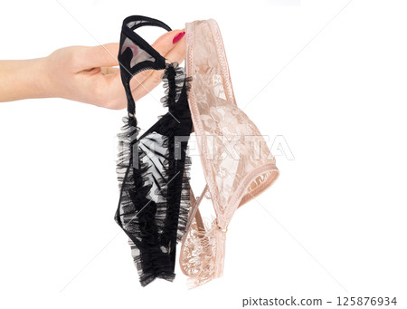 Hand Holding Lace Lingerie on White Background 125876934