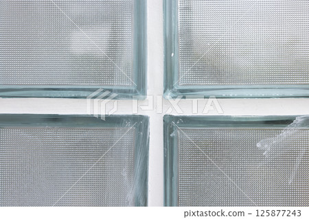 Clear glass block and concrete wall. 125877243