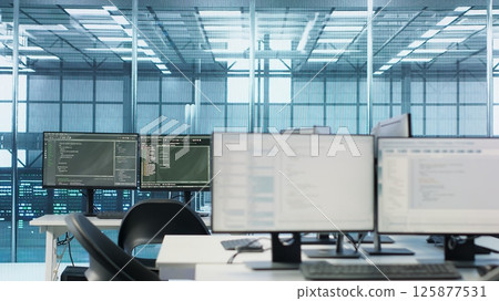 Code running on computer screens in empty data center workspace, used for troubleshooting rackmounts. Close up of script working on desktop PC monitors upgrading mainframes systems in server room Code running on computer screens in empty data center workspace, used for troubleshooting rackmounts. Close up of script working on desktop PC monitors upgrading mainframes systems in server room 125877531