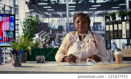 Successful woman boss collaborating with her experts team on online conference, focusing on problem solving, decision making and achieving strategic business objectives. Associates. Camera B. 125877555