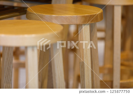 Wooden high back chairs in a restaurant 125877750