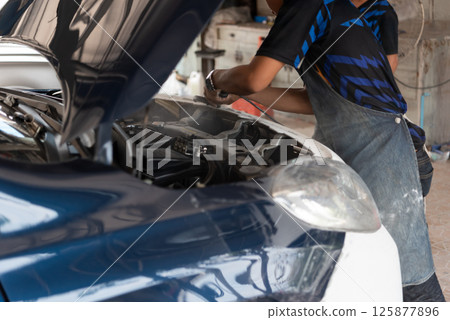 Checking car body work fiber bumper at car garage Checking car body work fiber bumper at car garage 125877896