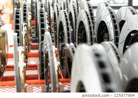 Checking car brake system for repair at car garage Checking car brake system for repair at car garage 125877904