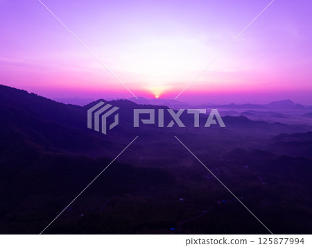 Aerial view landscape mountains colorful purple sky over sea 125877994
