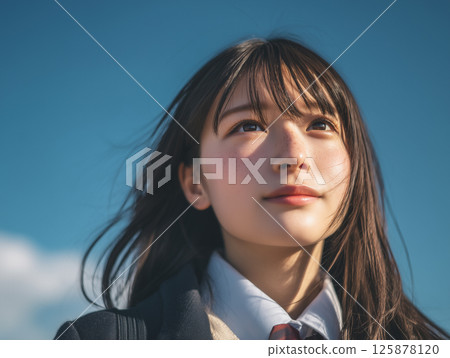 School girls looking up at the sky 125878120