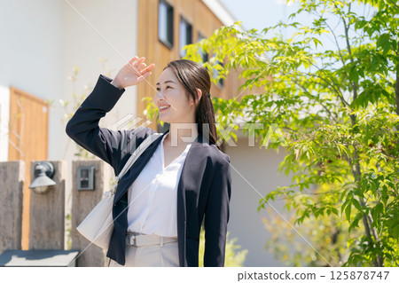 A woman in a suit leaving the entrance 125878747