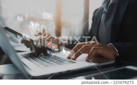 Professional in Suit Engaging with Digital Metrics and Analytics on Laptop, Focusing on SEO and Social Media Engagement Strategy XDMCP 125879273