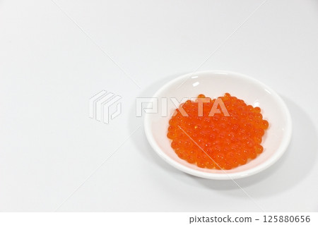 Salmon roe on a white plate 125880656