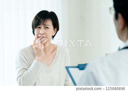 A woman receiving a medical examination A woman receiving a medical examination 125880898