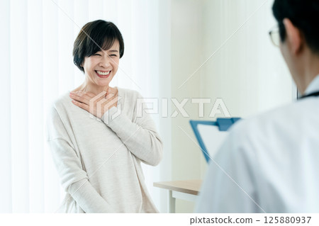 A woman receiving a medical examination 125880937