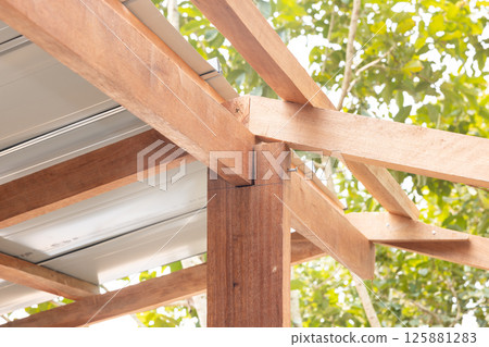Roof under construction with metal sheet and wood structure. 125881283