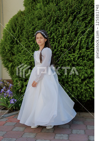 A little lady in a white dress prepares for the sacrament with quiet emotion. A sweet girl in a long white gown. A little lady in a white dress prepares for the sacrament with quiet emotion. A sweet girl in a long white gown. 125881748