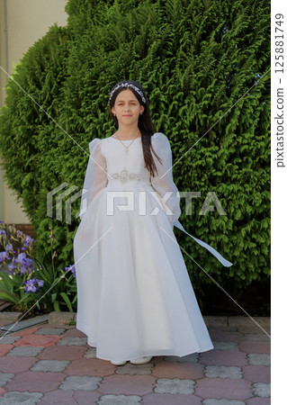 A little lady in a white dress prepares for the sacrament with quiet emotion. A sweet girl in a long white gown. 125881749