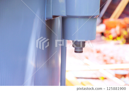 Plumber is installing pool filter system, checking connections gauges in backyard environment. 125881900