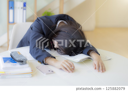 High school girl taking a nap at the desk High school girl taking a nap at the desk 125882079