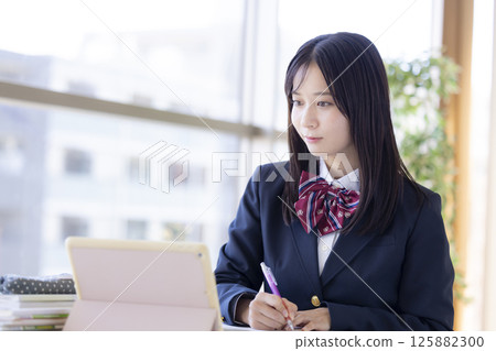 High school girls studying using a tablet 125882300