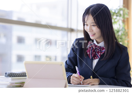 High school girls studying using a tablet High school girls studying using a tablet 125882301