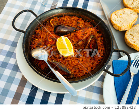 Plate of spaish dish seafood paella 125882428