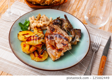 Appetizing lamb stew with boiled potatoes and white beans close up Appetizing lamb stew with boiled potatoes and white beans close up 125882449