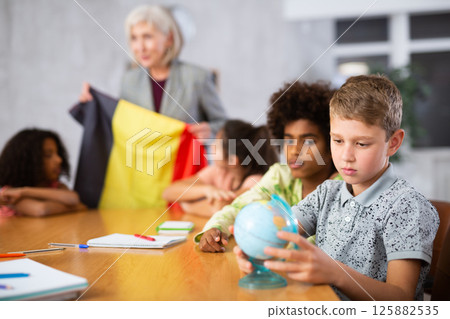 students listen to woman teacher who talks about Belgium students listen to woman teacher who talks about Belgium 125882535