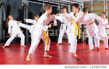 Boys and girls in kimono sparring together 125882590