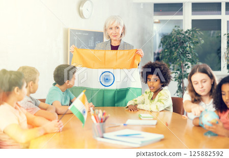 students listen to woman teacher who talks about India students listen to woman teacher who talks about India 125882592