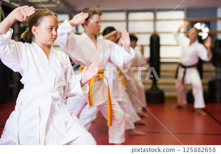 Young boys and girls in kimono doing kata Young boys and girls in kimono doing kata 125882658