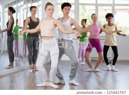 Teenage boy and girl rehearsing paired ballet Teenage boy and girl rehearsing paired ballet 125882707
