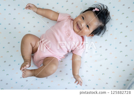 Joyful baby newborn smiling colorful blanket indoor cheerful atmosphere Joyful baby newborn smiling colorful blanket indoor cheerful atmosphere 125882728