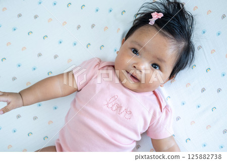Newborn baby smiling cuteness home indoor close-up joyful asian infant Newborn baby smiling cuteness home indoor close-up joyful asian infant 125882738