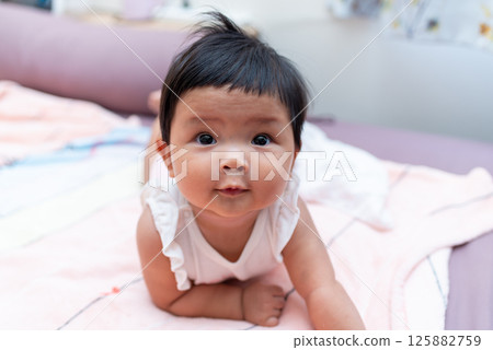Adorable asian newborn baby in cozy home setting captivating portrait soft colors gentle vibes 125882759