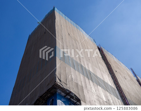 Construction progress update urban site clear sky low angle building development Construction progress update urban site clear sky low angle building development 125883086