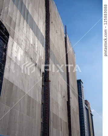 Construction workers scaling building facade urban cityscape high-rise environment safety focus Construction workers scaling building facade urban cityscape high-rise environment safety focus 125883088