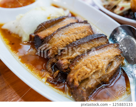 Delicious pork belly dish asian restaurant culinary cozy setting close-up flavorful experience 125883133