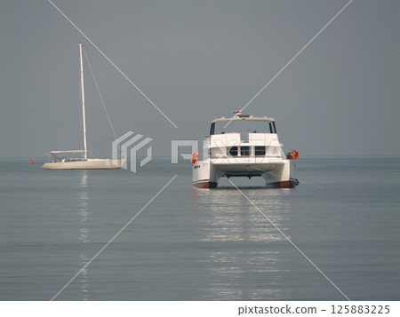 Boat adventure calm waters seaside tranquil wide angle exploration 125883225