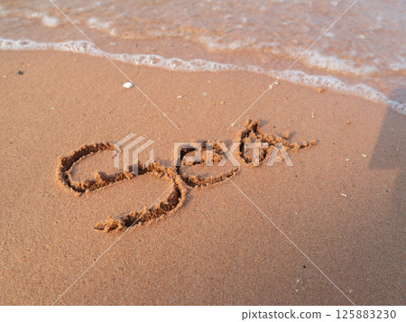 Writing the sand a personal message the beach coastal environment close-up view 125883230