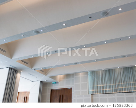 Bright modern ceiling design for corporate office interior a wide-angle perspective Bright modern ceiling design for corporate office interior a wide-angle perspective 125883363