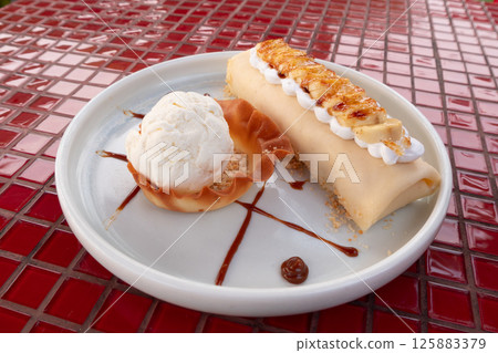 Delightful outdoor dessert platter with ice cream and sweet treats in a bright setting Delightful outdoor dessert platter with ice cream and sweet treats in a bright setting 125883379