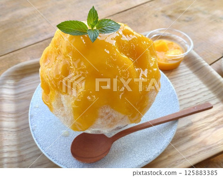 Shaved ice with mango syrup Shaved ice with mango syrup 125883385