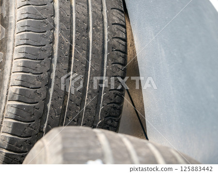 Inspecting vehicle tires for safety auto repair shop indoor close-up maintenance Inspecting vehicle tires for safety auto repair shop indoor close-up maintenance 125883442