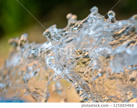 Dynamic water splash action outdoor setting nature close-up view fluid motion 125883468