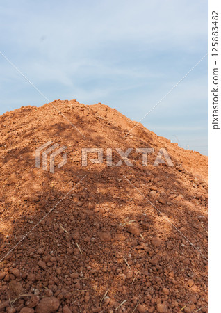 Outdoor construction site wide-angle action with heavy machinery and earth moving 125883482