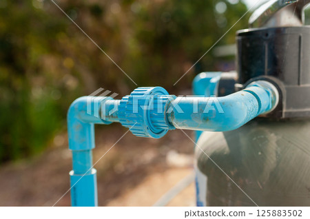 Installation of water pipe system in residential area home improvement outdoors close-up efficiency 125883502