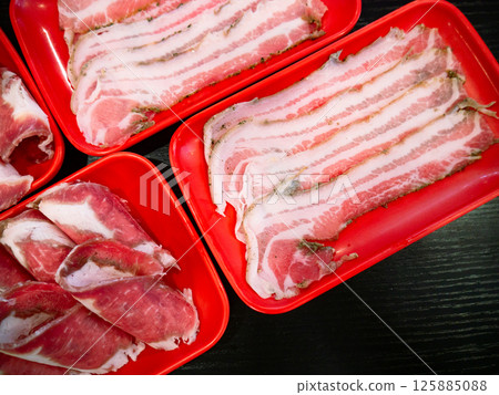 Sliced Meat and belly pork in tray for shabu or Sichuan mala hotpot on restaurant table. Sliced Meat and belly pork in tray for shabu or Sichuan mala hotpot on restaurant table. 125885088